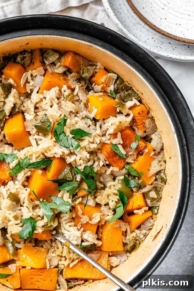 A steaming pot of creamy Easy Pumpkin Rice, garnished with fresh herbs, ready to be served.