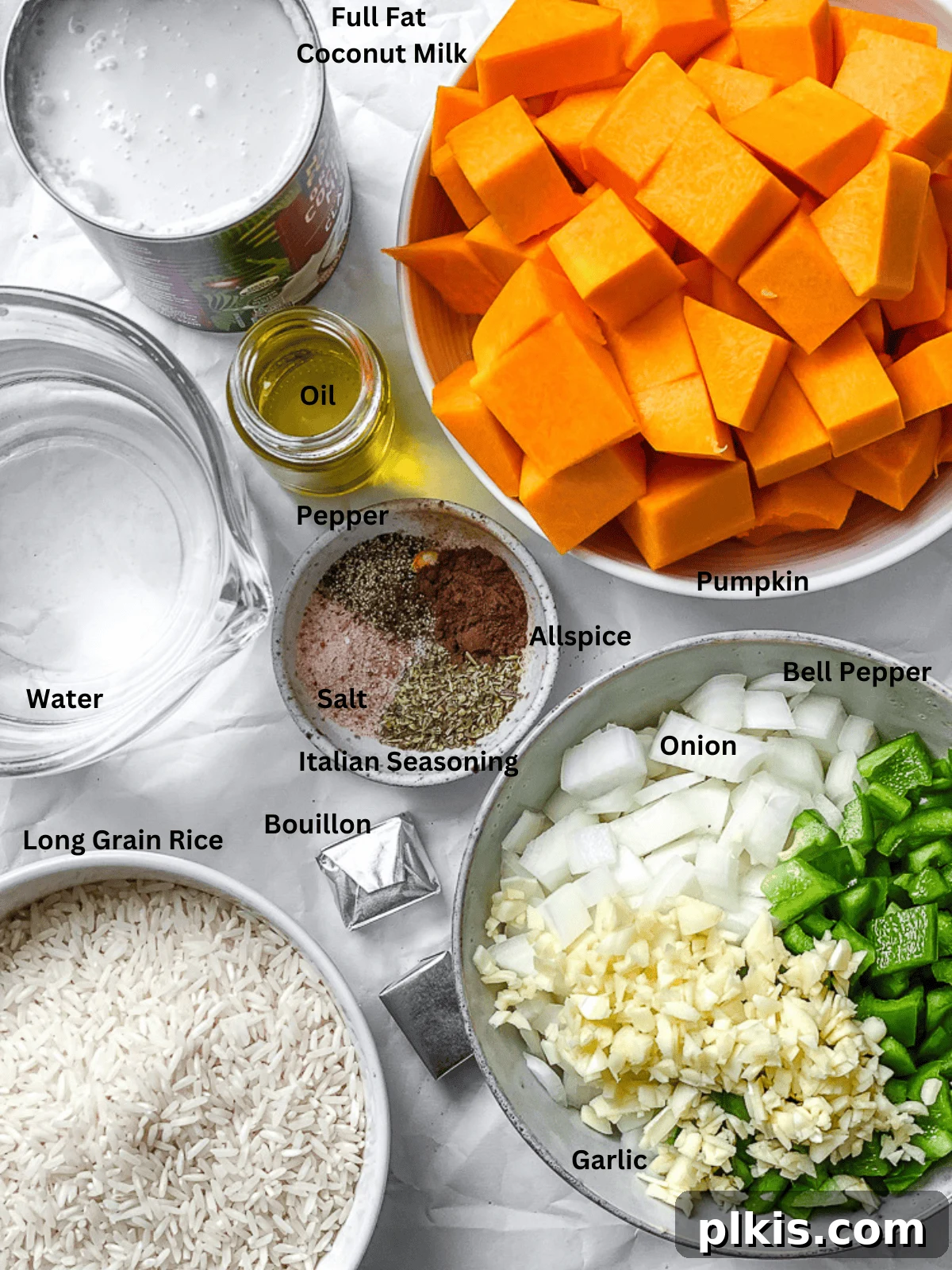 Measured out ingredients for Easy Pumpkin Rice, including diced pumpkin, onions, garlic, and spices, laid out on a clean white surface.