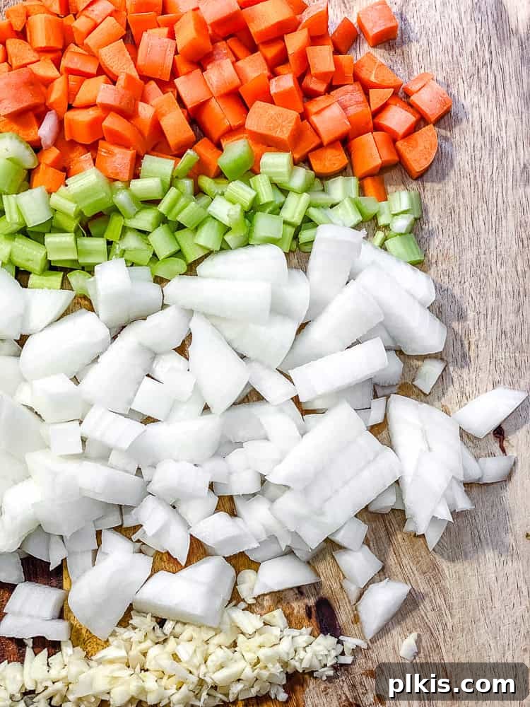 veggies for Tuscan White Bean Soup [With Kale] on a cutting board