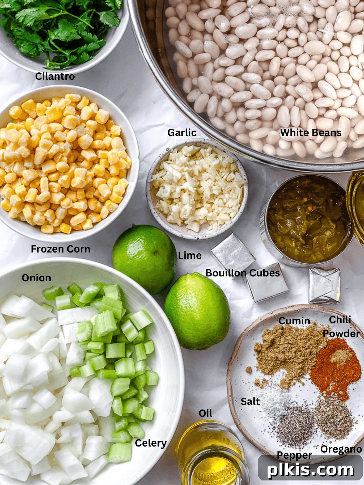 Creamy Plant-Based White Bean Chili 3 ingredients for Vegan White Bean Chili measured out on a white surface