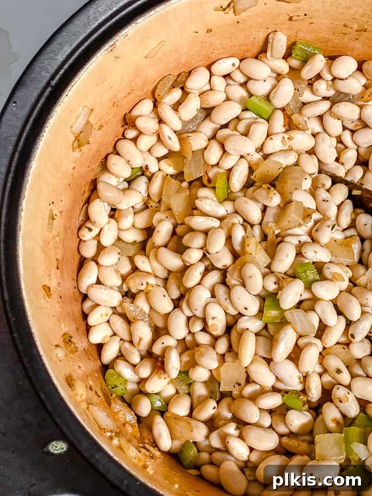 Creamy Plant-Based White Bean Chili 6 process shot showing soup cookin gin pot