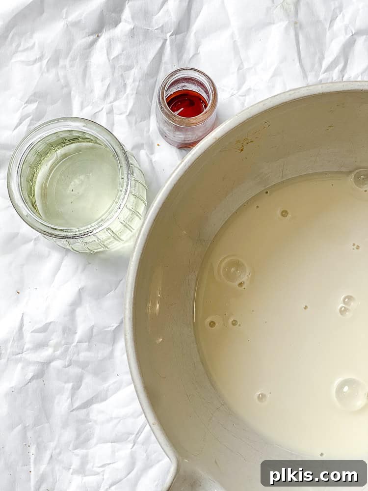 Plant-Based Red Velvet Perfection 4 Process shot showing all liquid and dry ingredients measured out in separate bowls, ready for mixing, with a large mixing bowl in the foreground.