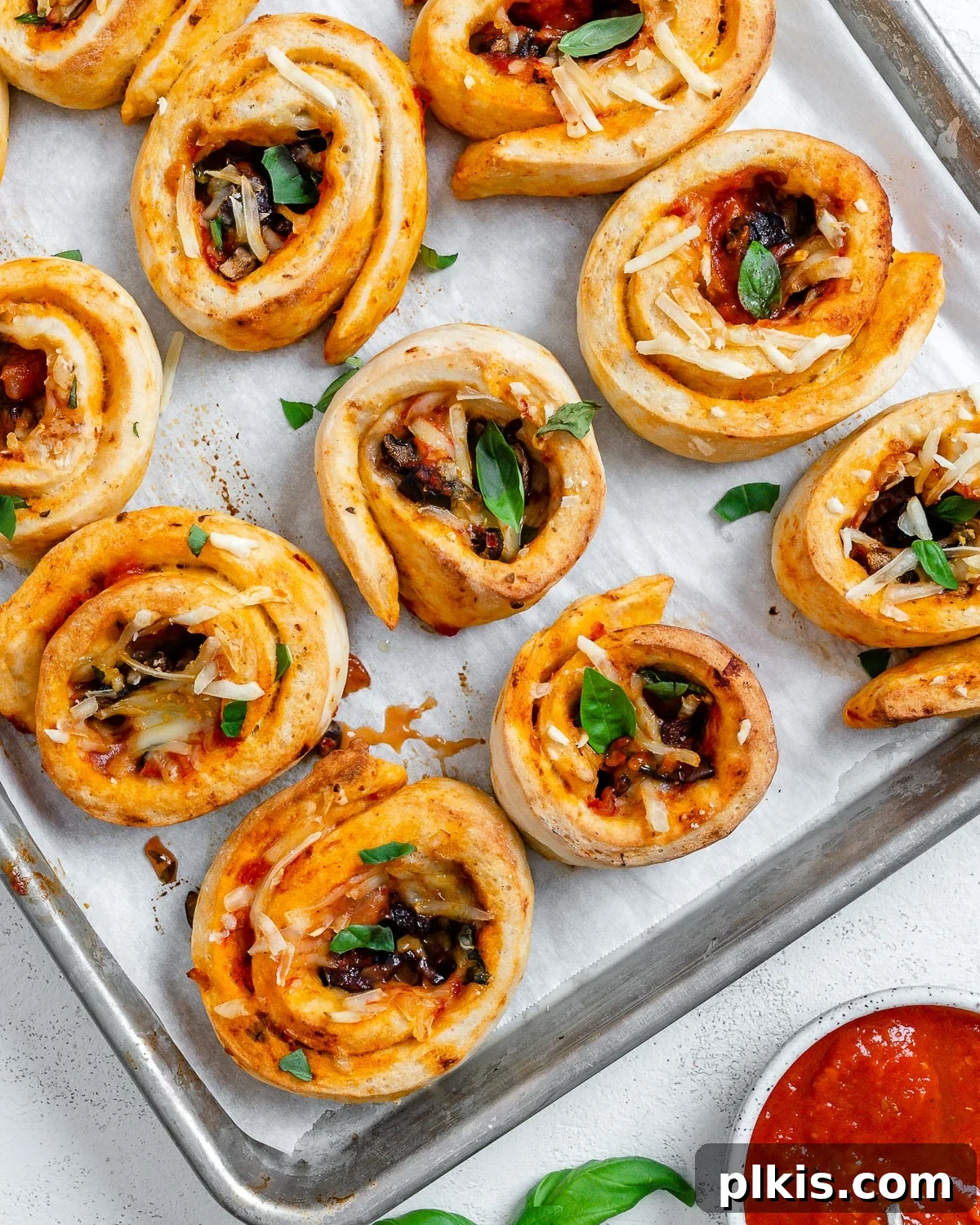 A final shot of the baked vegan pizza rolls in a rustic baking dish, highlighting their texture and appealing golden color.