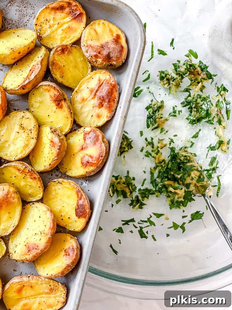 Rosemary Garlic Roasted Baby Potatoes 7 Process shot showing roasted baby potatoes being added to a bowl with the garlic-parsley paste, ready to be tossed.
