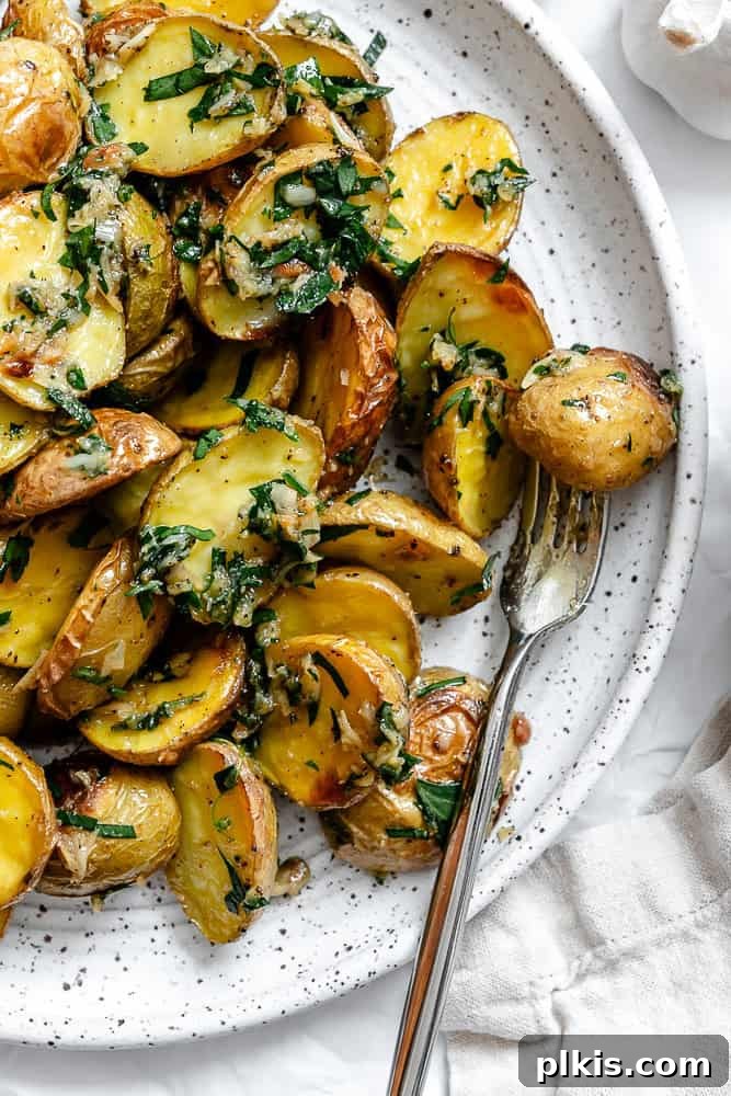 Rosemary Garlic Roasted Baby Potatoes 8 A completed plate of golden-brown Garlic Roasted Baby Potatoes, garnished with fresh parsley.