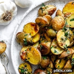 Rosemary Garlic Roasted Baby Potatoes 9 A plate of completed Garlic Roasted Baby Potatoes, garnished with fresh parsley.