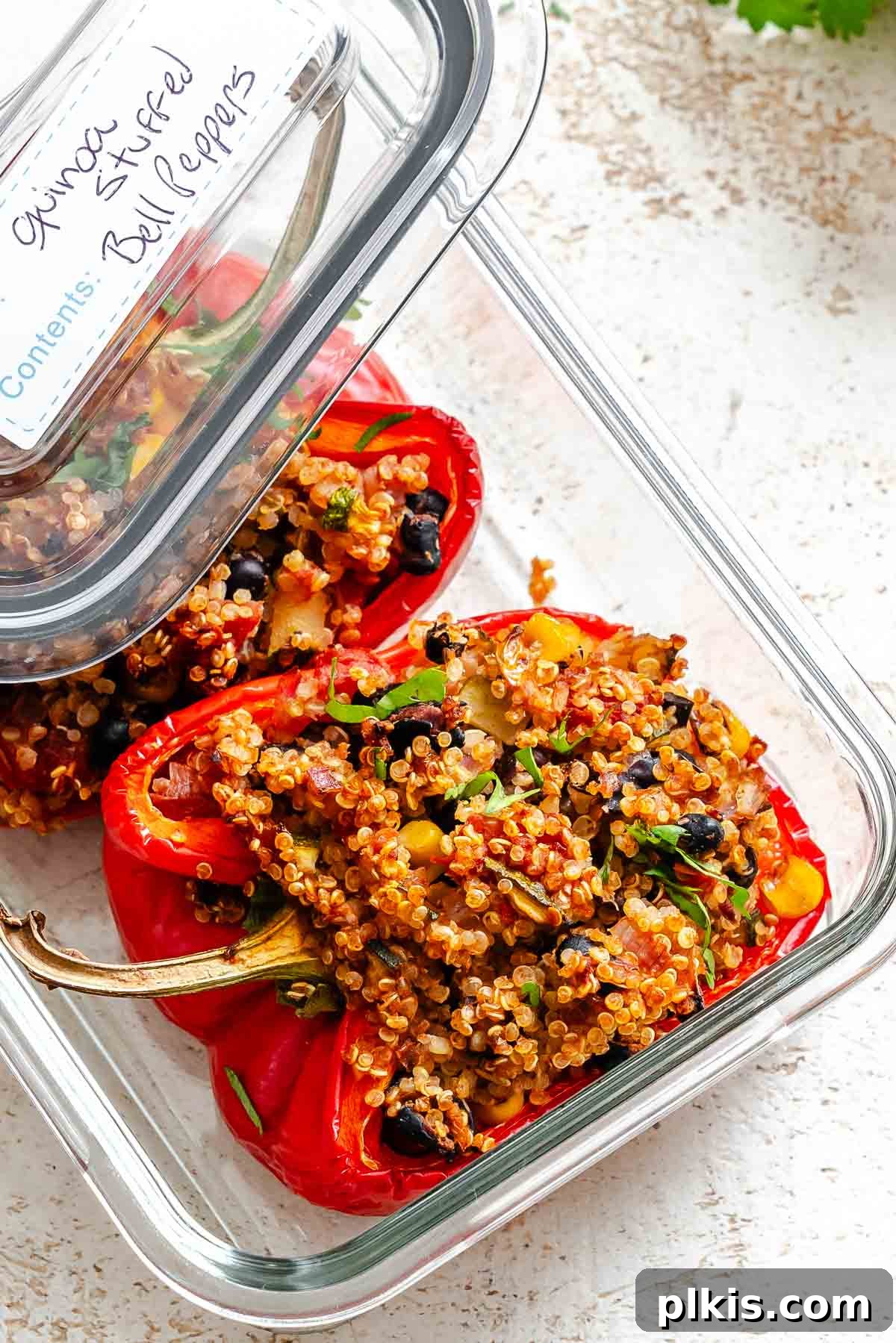 Wholesome Quinoa Stuffed Peppers 11 Completed Quinoa Stuffed Bell Peppers in a storage container, ready for meal prep.