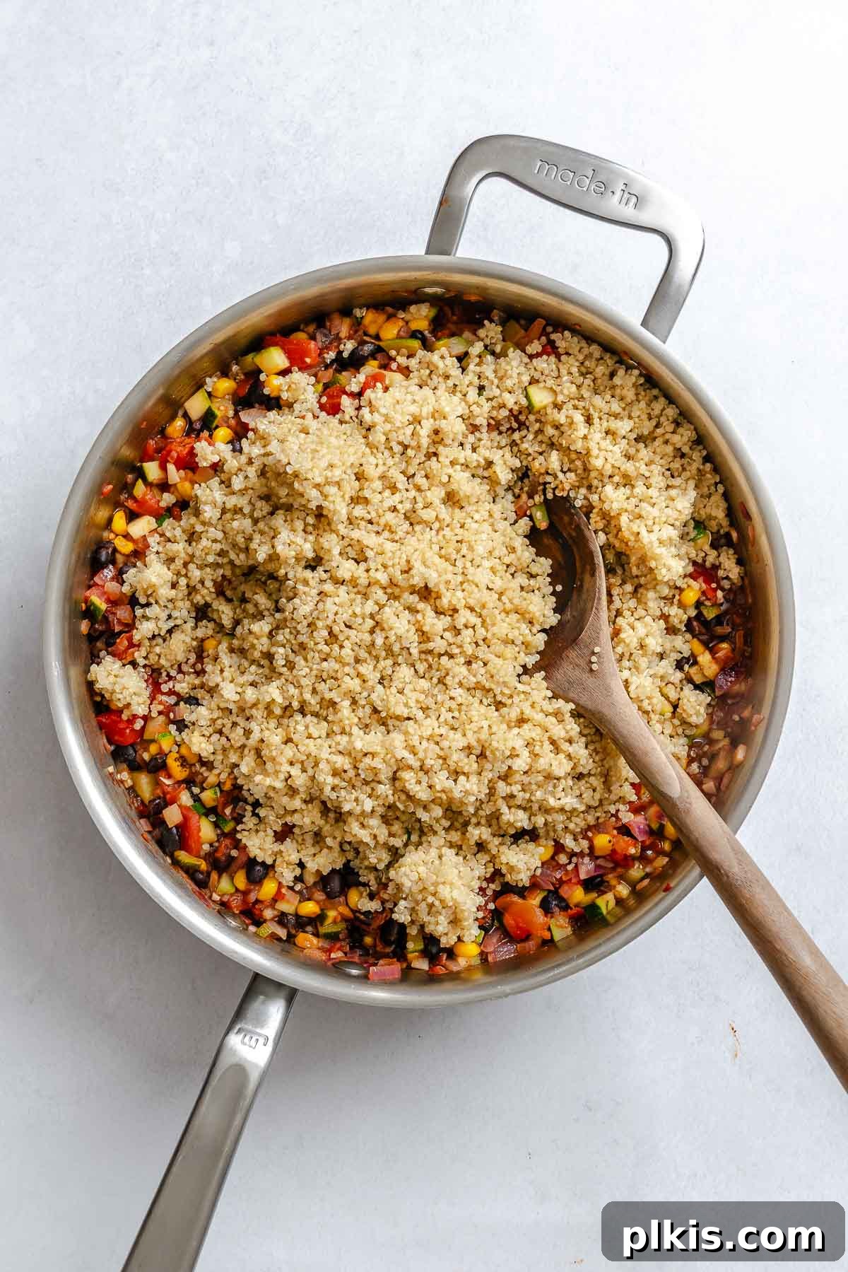 Wholesome Quinoa Stuffed Peppers 8 Process shot showing adding quinoa to pot.