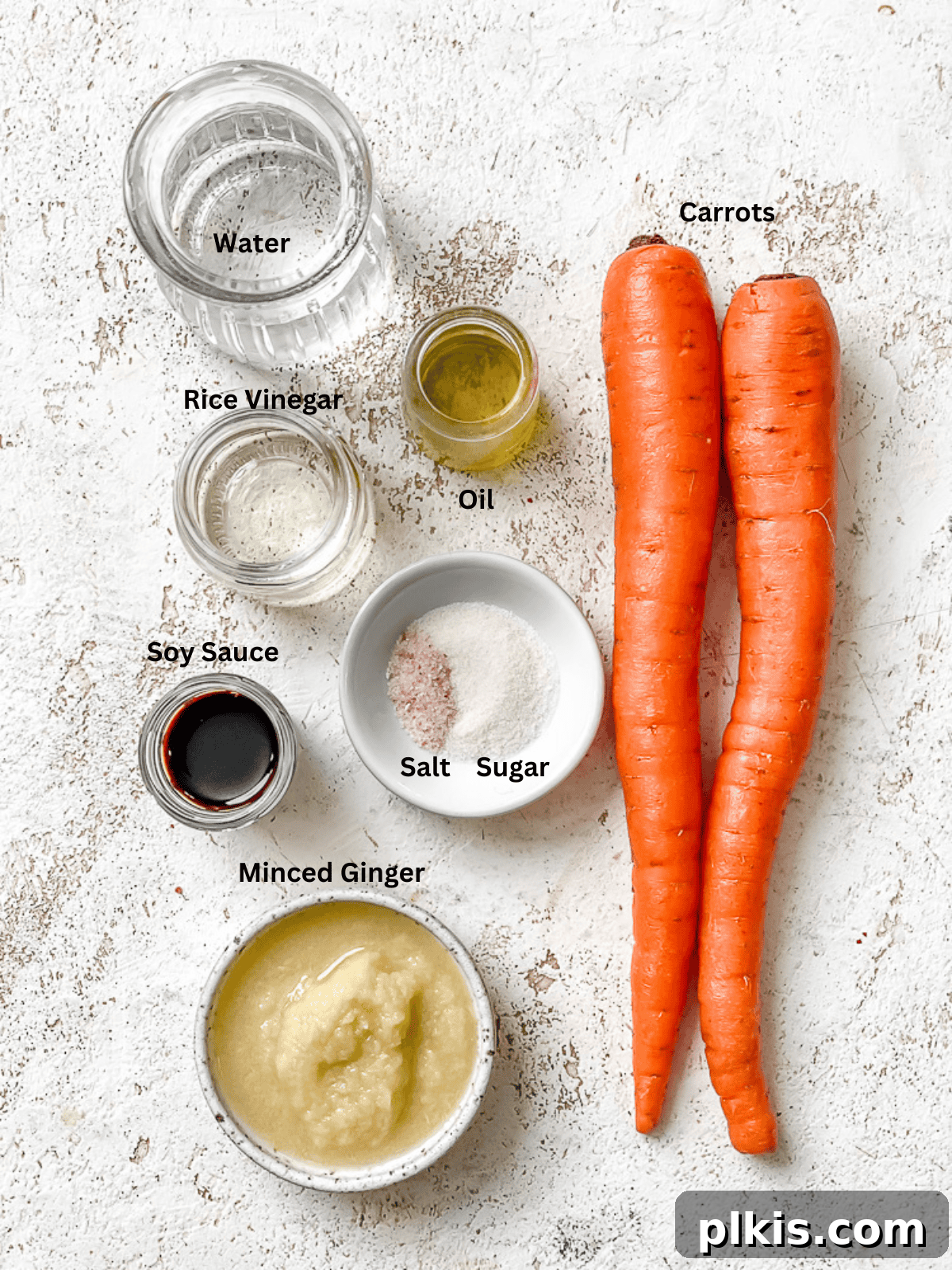 Vibrant Japanese Carrot Ginger Dressing 3 ingredients for Japanese Carrot Ginger Dressing measured out on a white surface, showcasing fresh produce and pantry staples