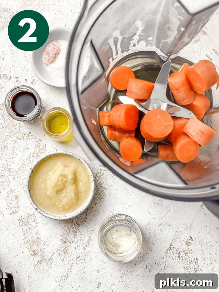 Vibrant Japanese Carrot Ginger Dressing 5 process shot showing cooked carrots added to blender alongside other dressing ingredients