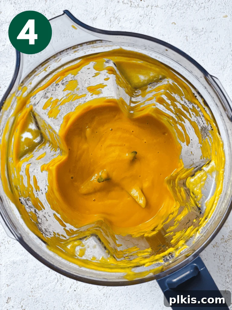 Vibrant Japanese Carrot Ginger Dressing 7 process shot showing the smooth, creamy dressing in the blender after processing
