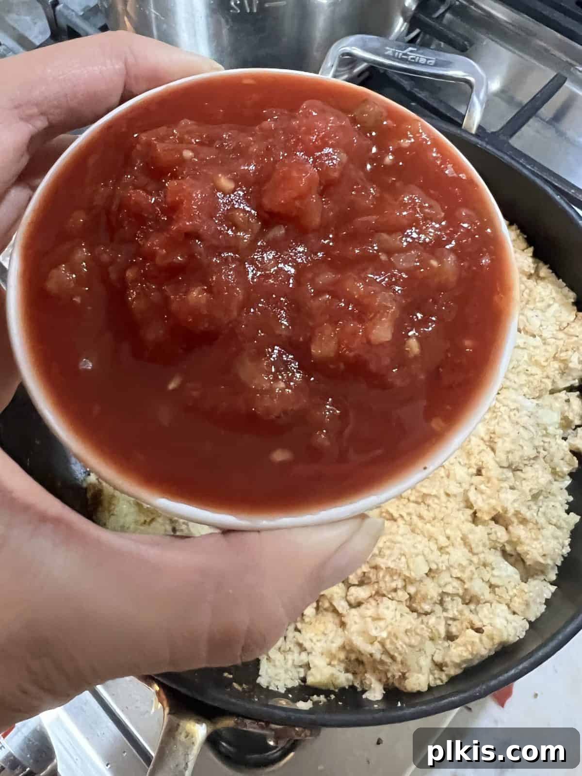 Quick and Flavorful Spanish Cauliflower Rice Bowl with Salsa 10 process of adding salsa to cauliflower rice