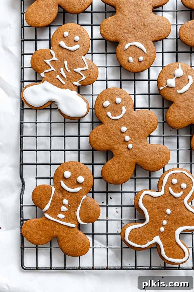 Cozy Vegan Gingerbread Delights 2 Beautifully decorated vegan gingerbread cookies cooling on a wire rack, ready for holiday enjoyment.