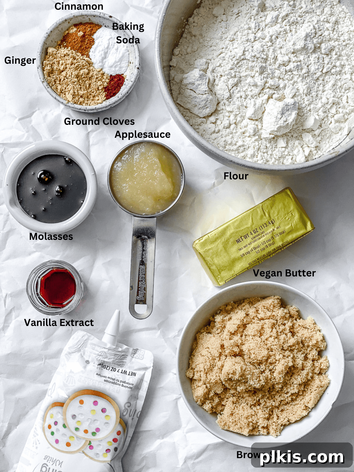 Cozy Vegan Gingerbread Delights 3 Ingredients for Vegan Gingerbread Cookies neatly arranged on a white surface, showcasing the fresh spices and wet components.
