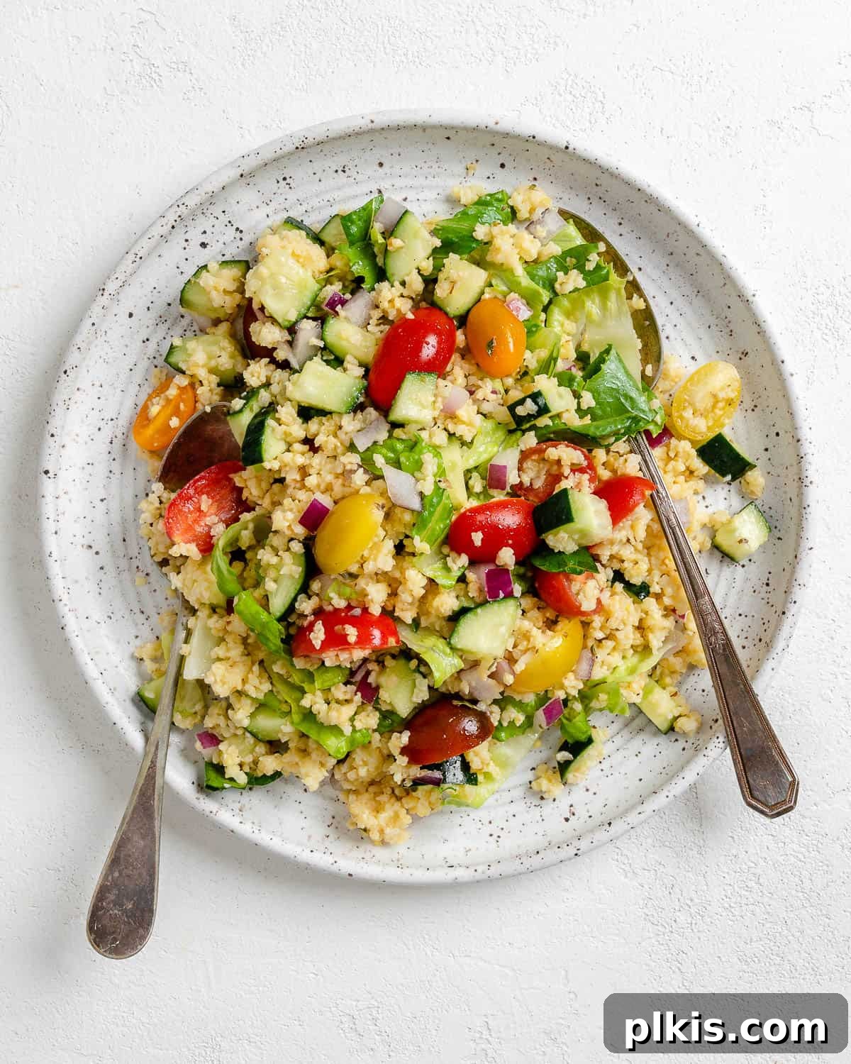 Vibrant Vegan Greek Millet Bowl 15 The final presentation of a hearty Vegan Greek Millet Salad, beautifully served on a white plate against a bright, airy background, ready to be enjoyed.
