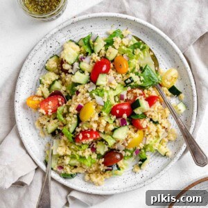 Vibrant Vegan Greek Millet Bowl 16 completed Vegan Greek Millet Salad on a white plate against a light background
