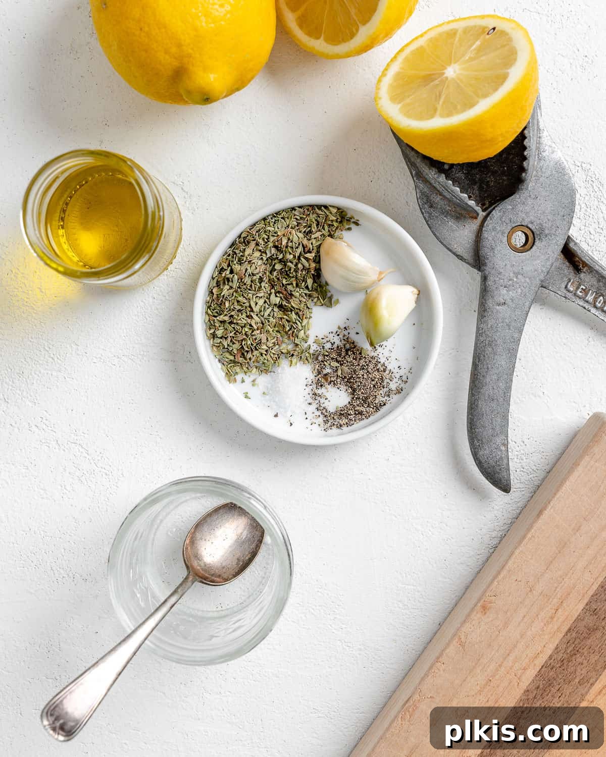 Vibrant Vegan Greek Millet Bowl 5 The process of mixing spices and lemon juice into a small white bowl to create the salad dressing, set against a clean white background.