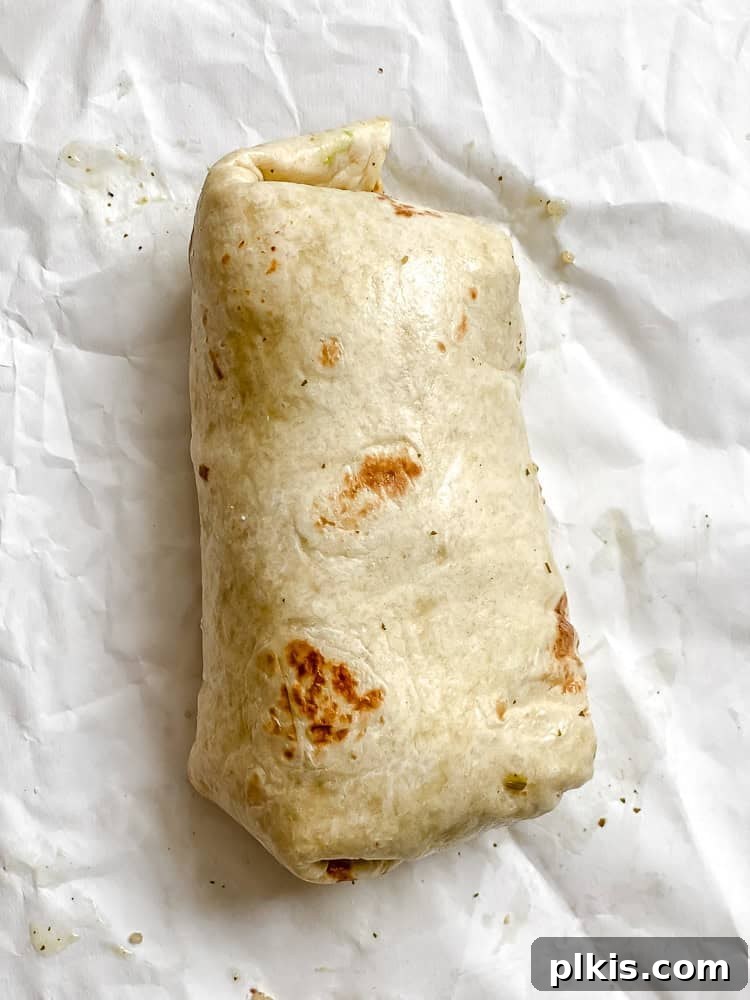 Hearty Quinoa Black Bean Burritos 7 process shot showing a fully wrapped burrito in a tortilla