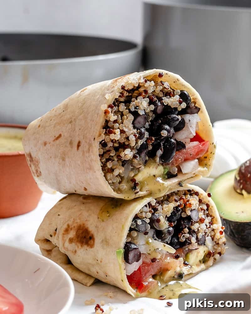 Hearty Quinoa Black Bean Burritos 8 completed Quinoa Black Bean Burritos stacked on one another, beautifully presented