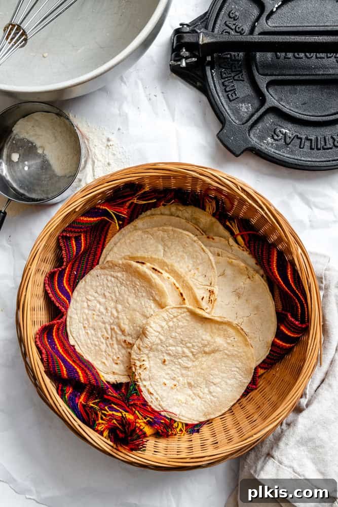 Crafting Perfect Corn Tortillas at Home 2 Freshly made homemade corn tortillas neatly stacked in a traditional woven basket, ready to be served.