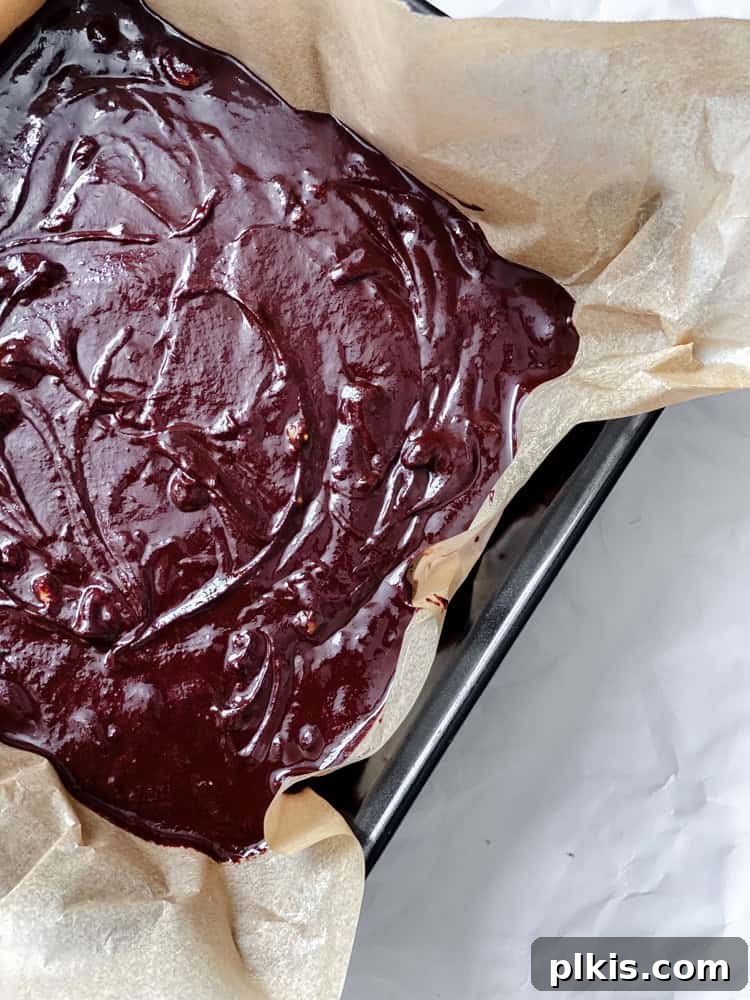 Easy Microwave Vegan Fudge 6 process shot showing chocolate fudge being added to baking dish
