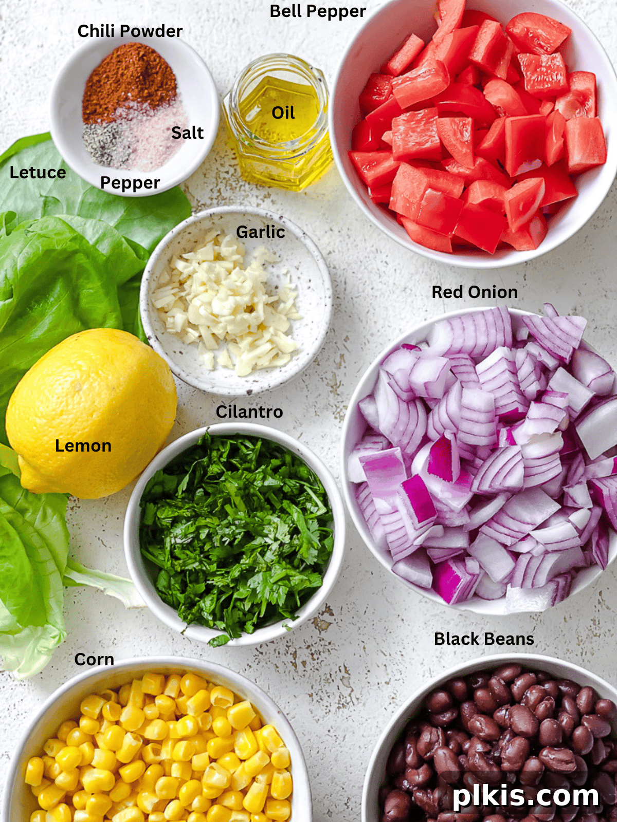 Soulful Vegan Black Eyed Pea Soup 3 A vibrant selection of fresh ingredients including black eyed peas, onions, garlic, bell peppers, and celery, carefully arranged on a white surface, ready for soup preparation.