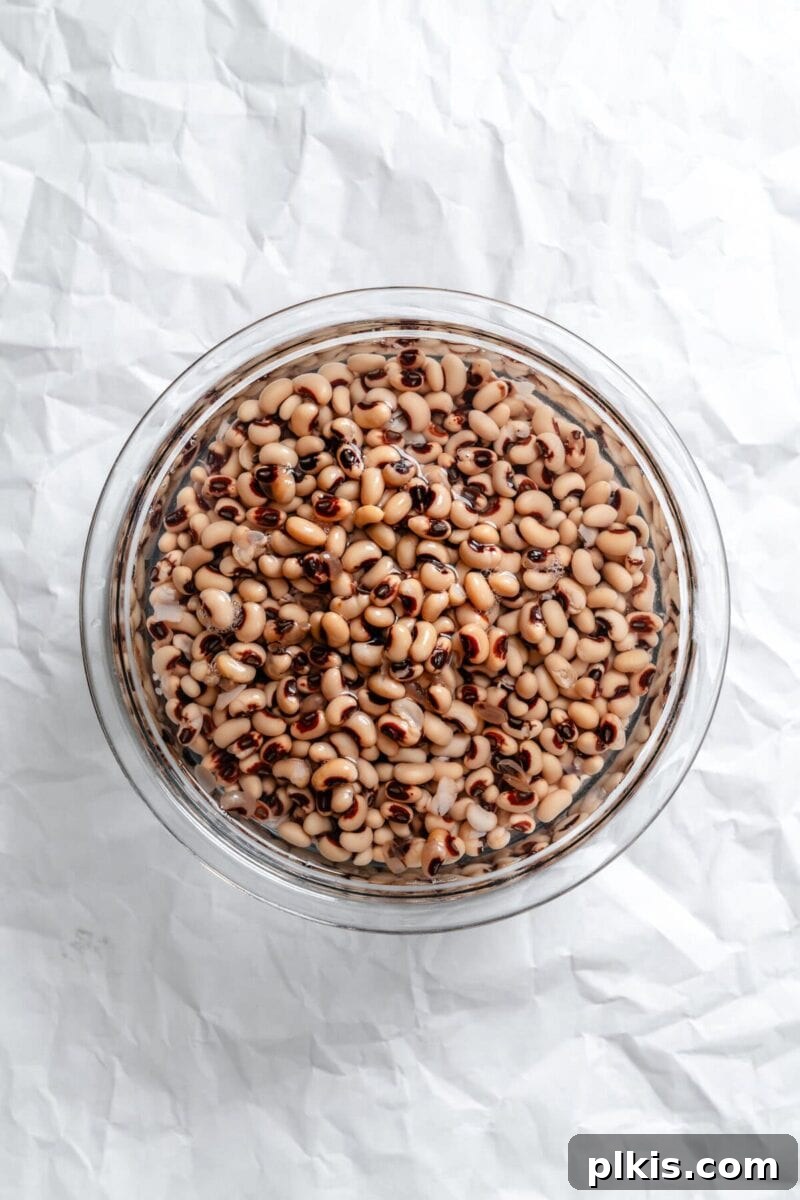 Soulful Vegan Black Eyed Pea Soup 4 Process shot showing dried black eyed peas soaking in a bowl of water, preparing them for cooking.