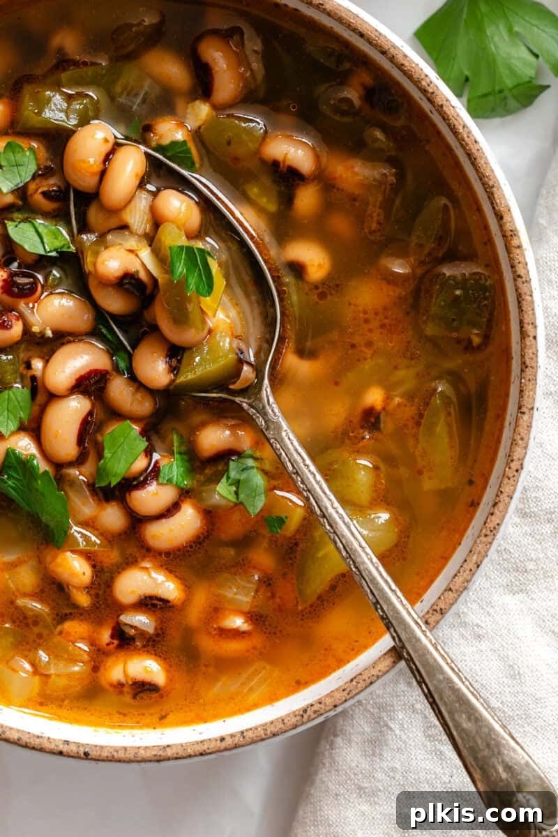 Soulful Vegan Black Eyed Pea Soup 7 A beautifully presented bowl of completed Vegan Black Eyed Pea Soup, garnished with fresh herbs, ready to be enjoyed.