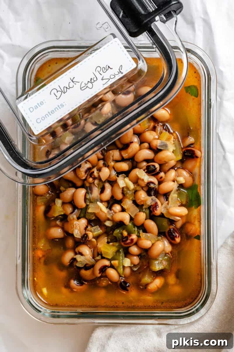 Soulful Vegan Black Eyed Pea Soup 8 A portion of Vegan Black Eyed Pea Soup stored neatly in an airtight glass container, ready for refrigeration or freezing.