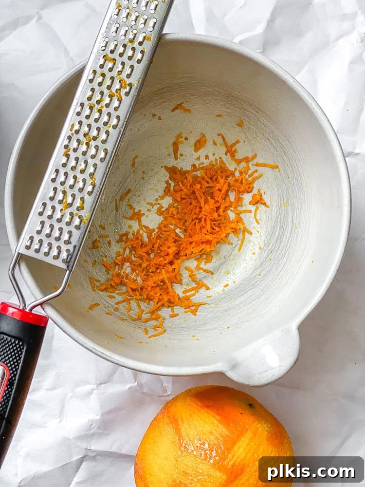 Bright Orange Vinaigrette 4 process shot showing grating orange into a bowl for zest