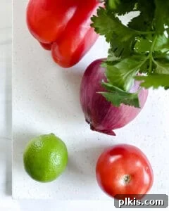 Bell pepper, red onion, and tomato diced for the mixed bean salad.