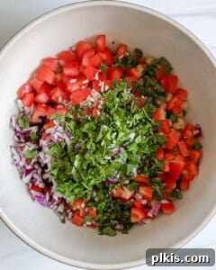 Mixing the ingredients of the mixed bean salad in a bowl.