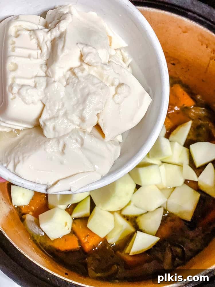 Sweet Autumn Squash and Apple Bisque 6 Process shot of adding tofu to pot.