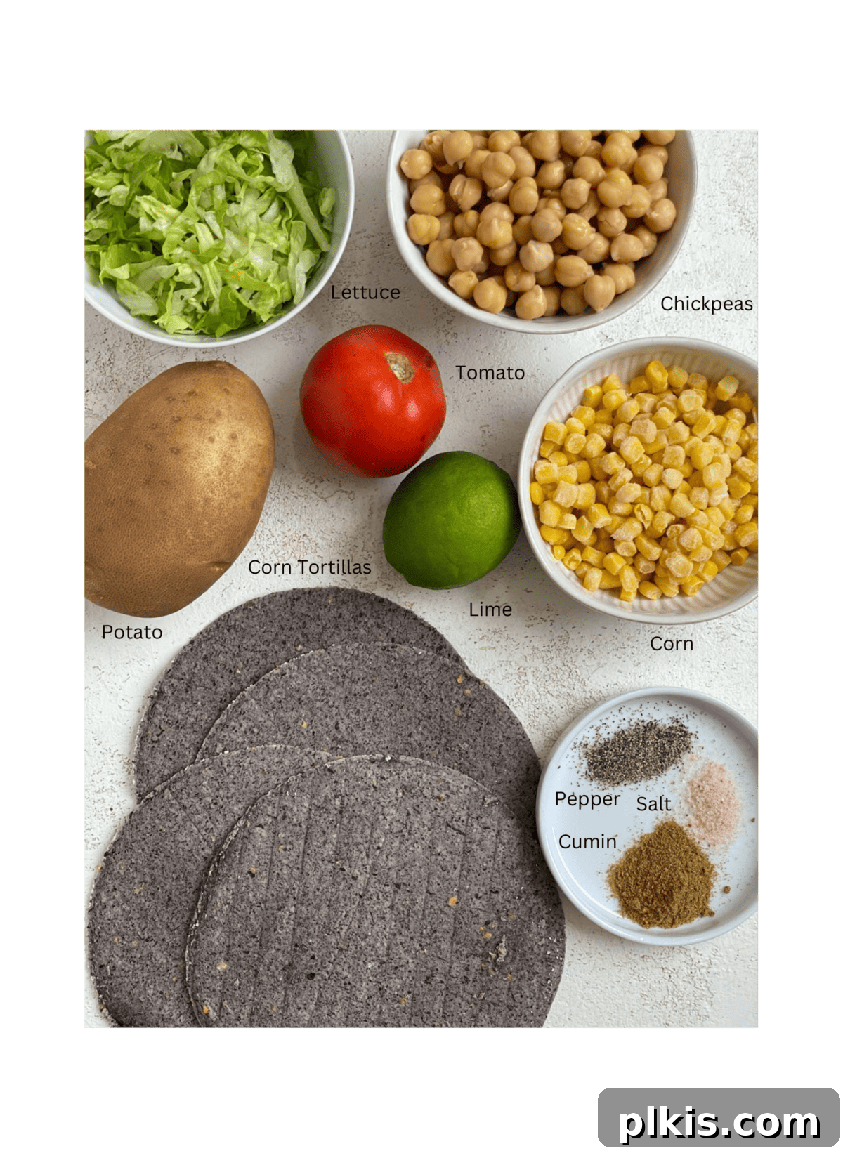 Golden Potato and Chickpea Tacos 3 A selection of fresh ingredients including potatoes, chickpeas, cumin, salt, and pepper, meticulously measured and arranged on a light background, ready for making potato and chickpea tacos.