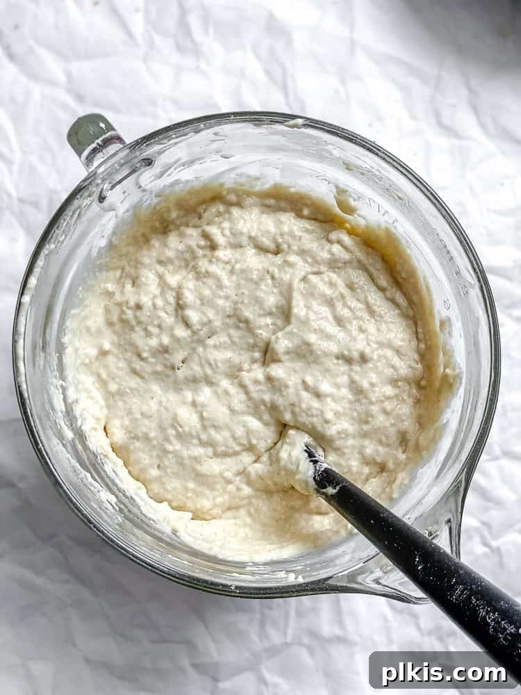 Process shot showing mixing ingredients in a bowl.