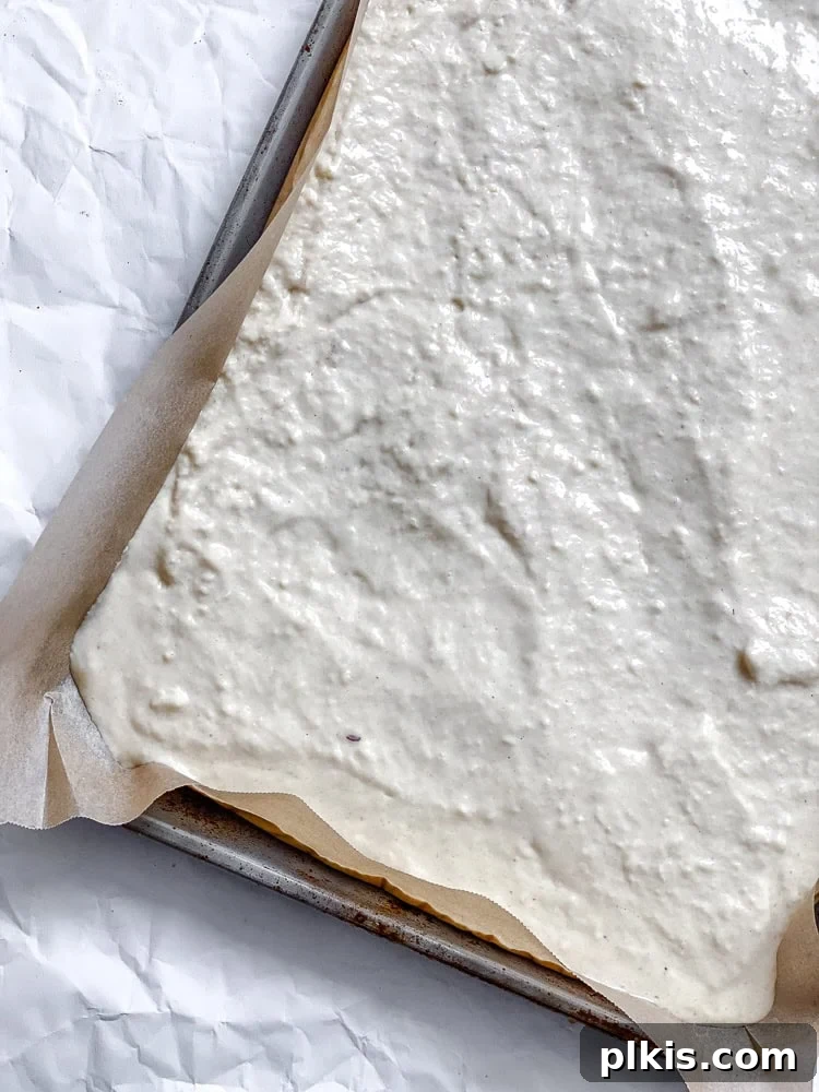 Process shot showing batter added to sheet pan.