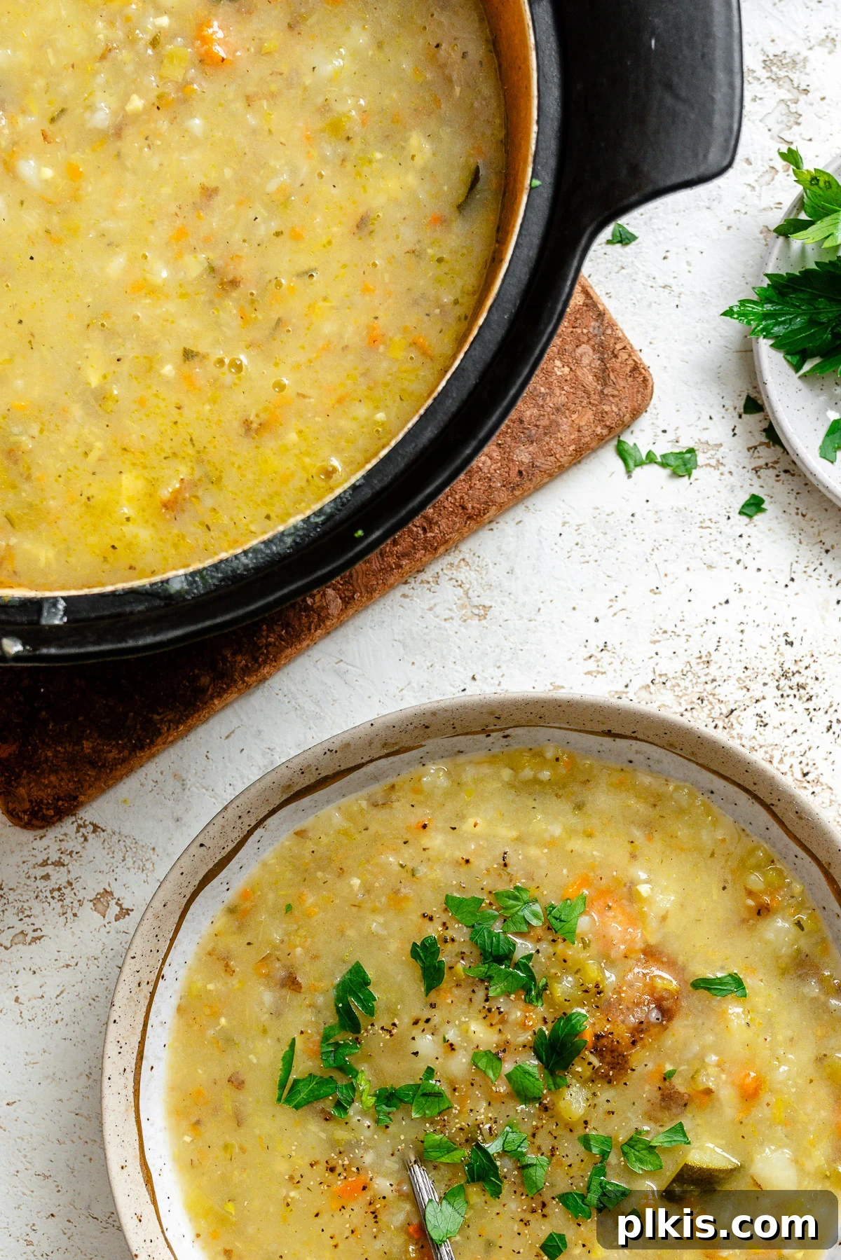 Hearty Vegan Potato and Vegetable Soup 8 Two bowls of Vegan Potato Soup, one in a pot and one ready to serve, symbolizing abundance and easy storage.