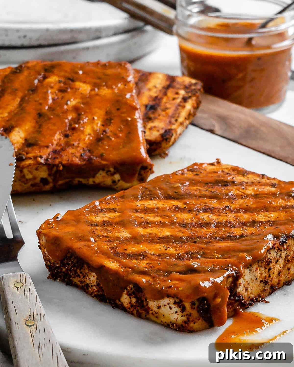 Next-Level Grilled Tofu Steaks 2 Flavorful grilled tofu steaks, perfectly plated and ready to serve as a delicious vegan meal