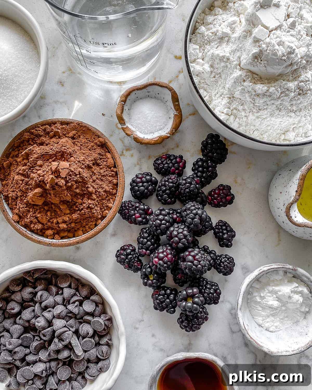Rich Chocolate Blackberry Delights 3 Ingredients for Vegan Blackberry Chocolate Cupcakes measured out on a white surface, ready for mixing.
