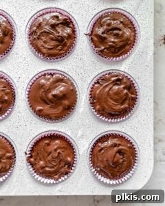 Rich Chocolate Blackberry Delights 9 Vegan Blackberry Chocolate Cupcakes batter in a muffin tin, ready to go into the oven.