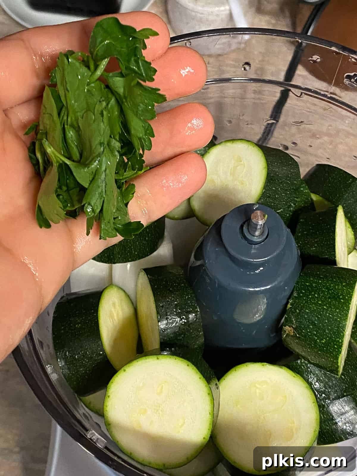Wholesome Baked Plant-Based Zucchini Fritters 6 process of adding parsley to food processor
