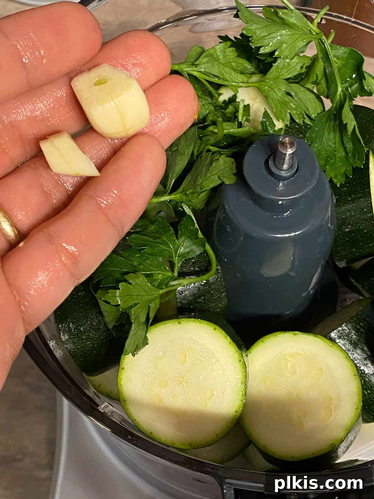 Wholesome Baked Plant-Based Zucchini Fritters 7 process of adding garlic to food processor