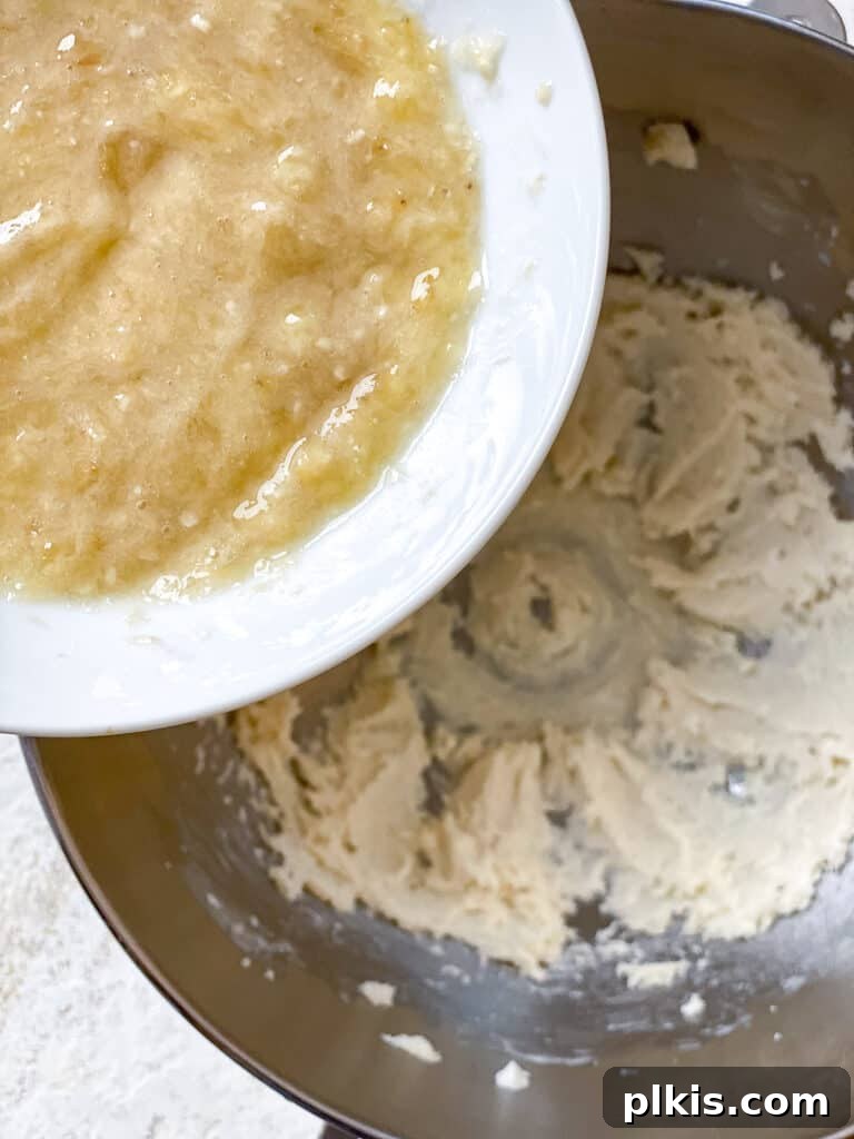 Wholesome Zucchini Oat Delights 11 process shot of adding mashed banana to bowl