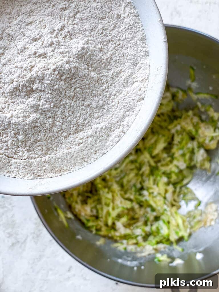 Wholesome Zucchini Oat Delights 17 process shot of adding flour mixture to bowl