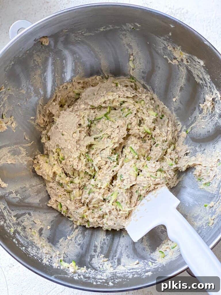 Wholesome Zucchini Oat Delights 19 process shot showing mixing of ingredients together in bowl