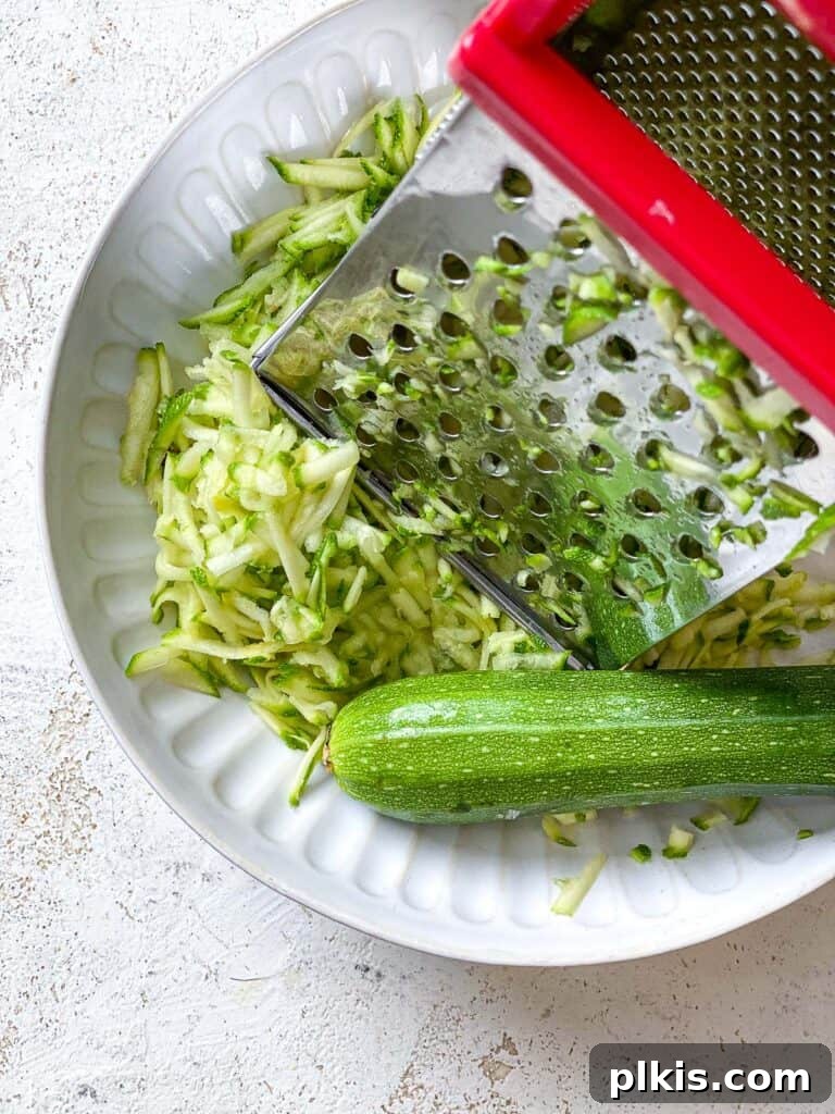 Wholesome Zucchini Oat Delights 4 process shot of grating zucchini onto plate