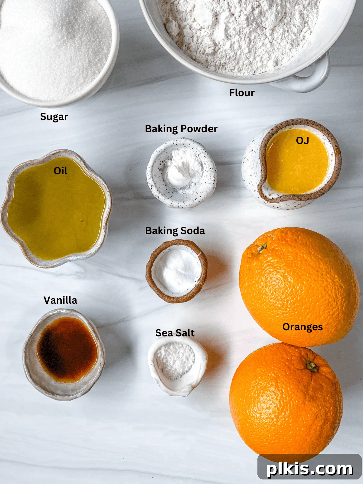 Sun-Kissed Orange Olive Oil Cake 3 All the measured ingredients for Orange Olive Oil Cake, neatly laid out on a white surface, ready for baking.