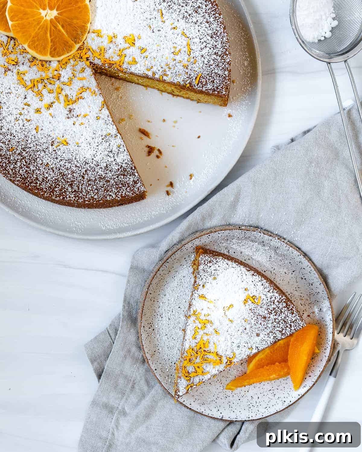 Sun-Kissed Orange Olive Oil Cake 8 A freshly baked slice of Orange Olive Oil Cake, showcasing its golden crust and moist, tender interior, presented against a clean white background.