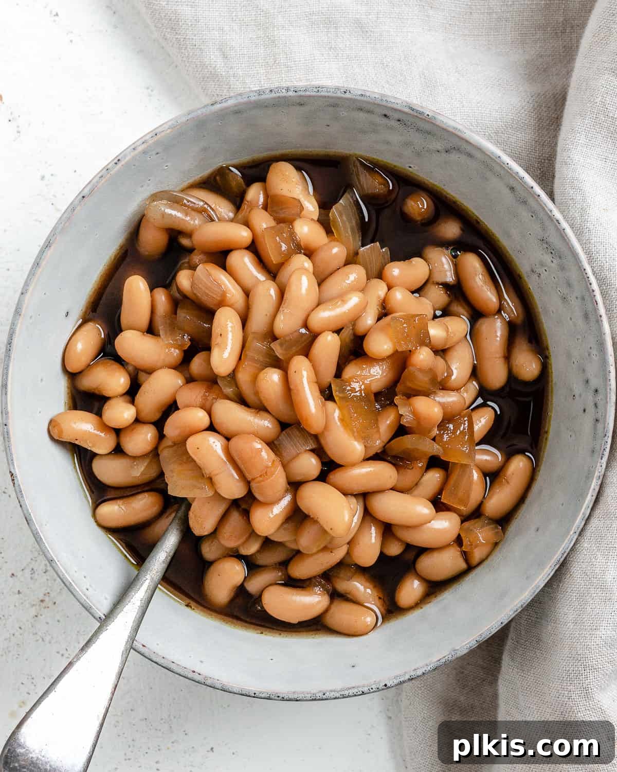 Homestyle Vegan Slow Cooker Baked Beans 8 Completed Vegan Slow Cooker Baked Beans in a white serving bowl, garnished