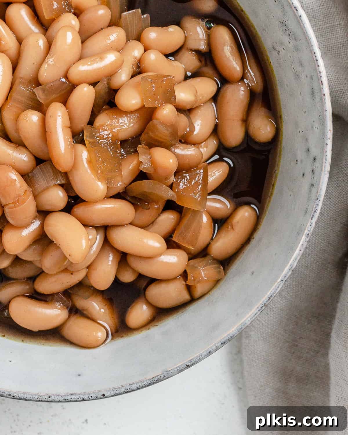 Homestyle Vegan Slow Cooker Baked Beans 9 Close-up of a serving of Vegan Slow Cooker Baked Beans in a white bowl